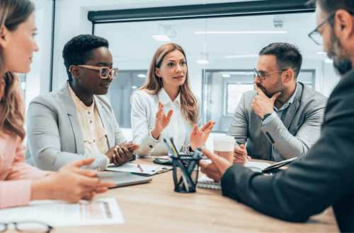 A group of business leaders, both men and women, representing gender diversity in leadership.