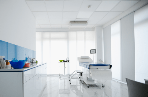 A dermatology clinical research room equipped with a table and chairs for dermatology studies.